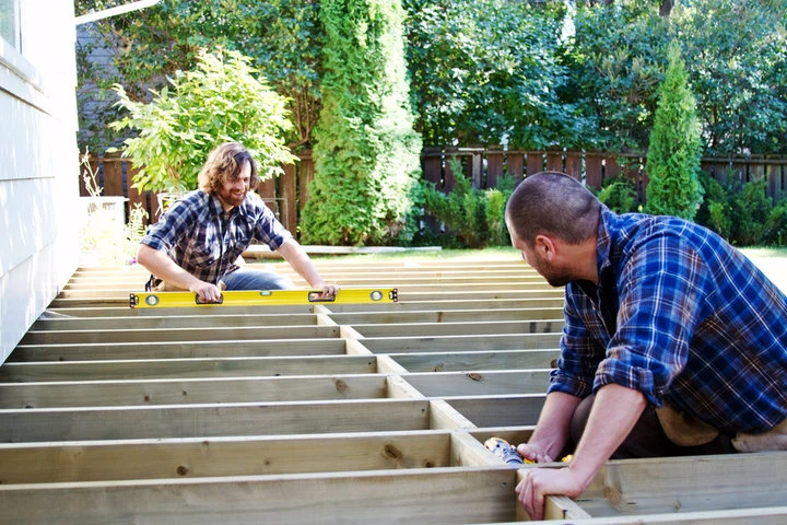 Deck builders reinforcing the structural framework of a residential custom deck in Las vegas